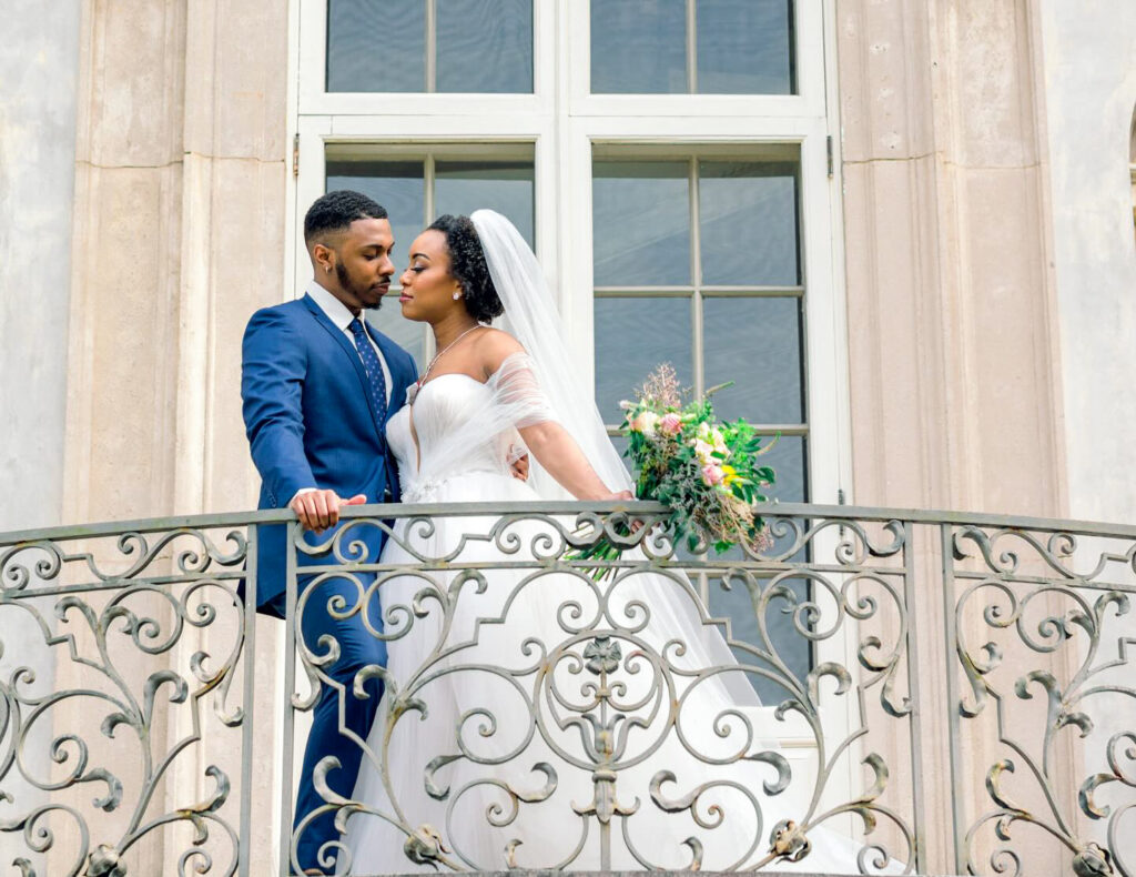 Luxury documentary Atlanta wedding photographer capturing bride and groom on the iconic Swan House balcony with timeless editorial architecture in Atlanta