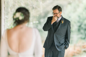 Documentary Atlanta wedding photography capturing an emotional groom wiping away tears during a first look
