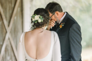Bride and groom sharing an emotional embrace after their first look captured by a Luxury Atlanta Wedding Photographer