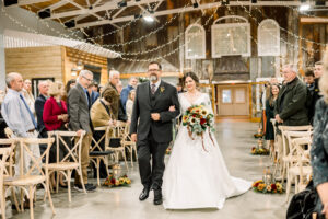 Luxury Atlanta Wedding Photographer capturing an emotional wedding aisle entrance surrounded by loved ones