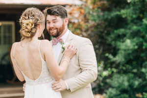 Emotional wedding photo of bride and groom smiling together after a heartfelt first look